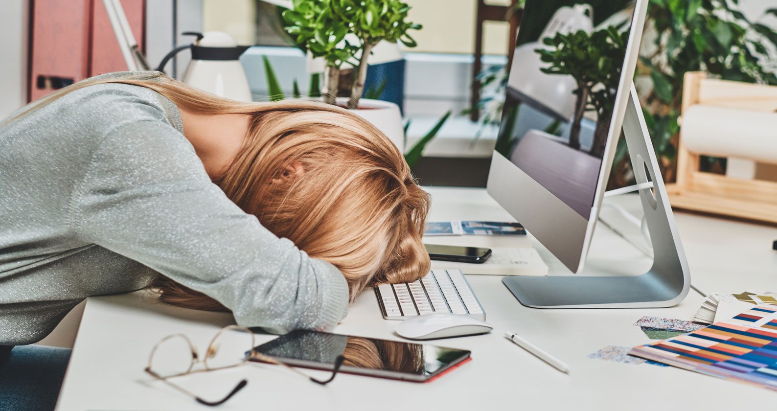 A student with her head resting on her arms.