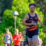 Man running wearing workout gear.