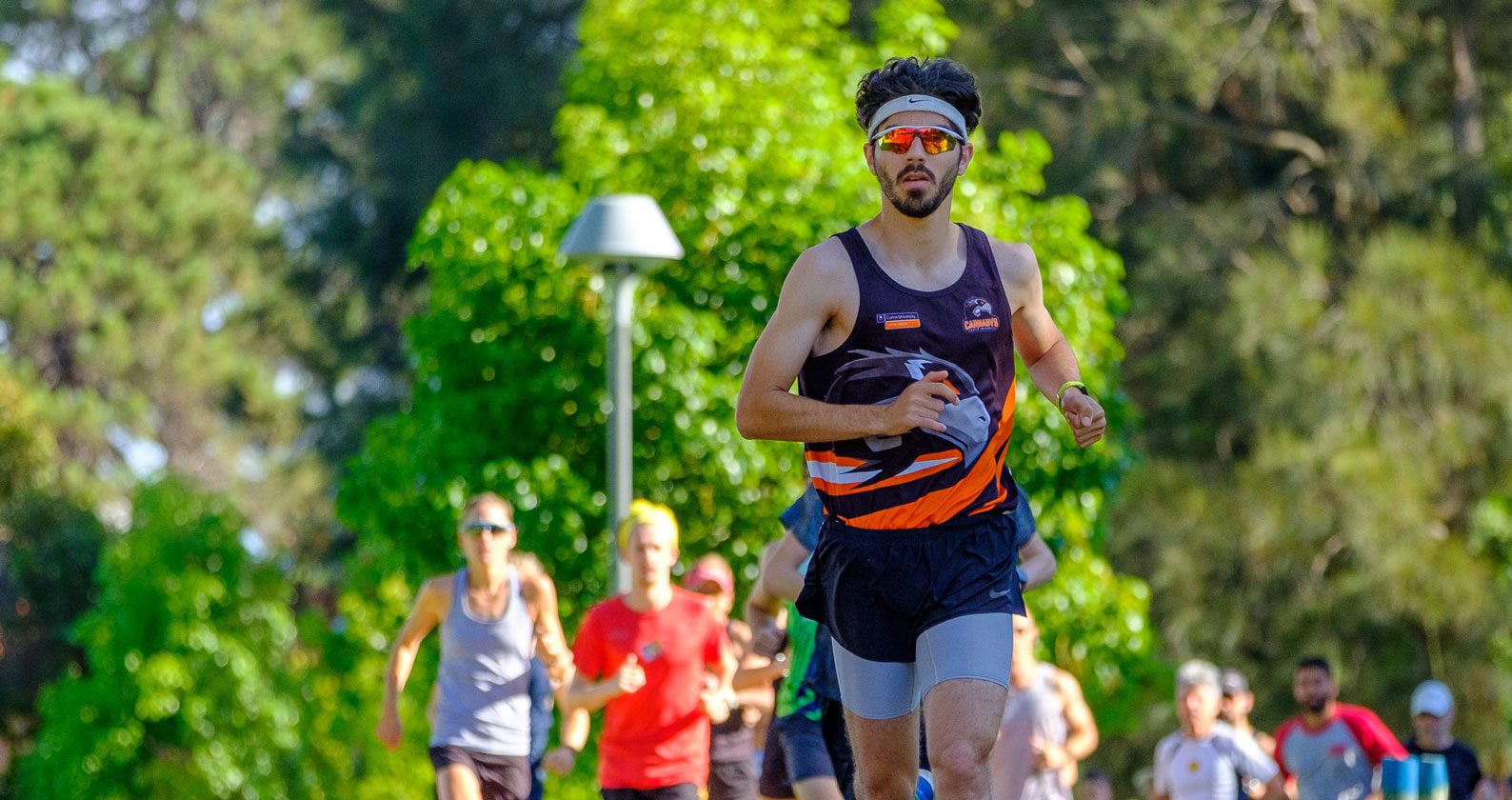 Man running wearing workout gear.