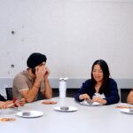 The hosts discussing the lamington in front of them