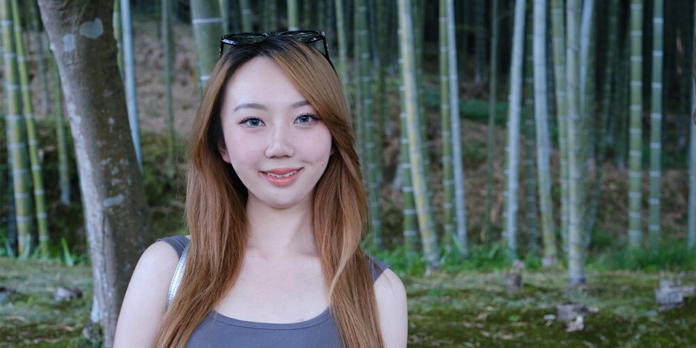 Female student YT Wan poses for a photo outdoors.