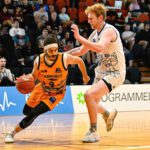 A Carnabys basketball player facing off against another player on the court.