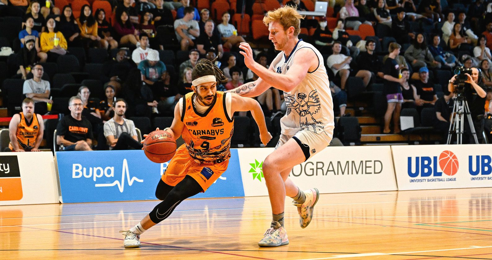 A Carnabys basketball player facing off against another player on the court.