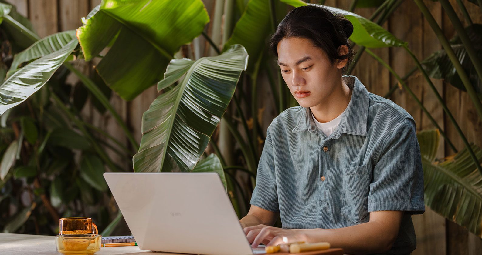 Student typing on laptop.