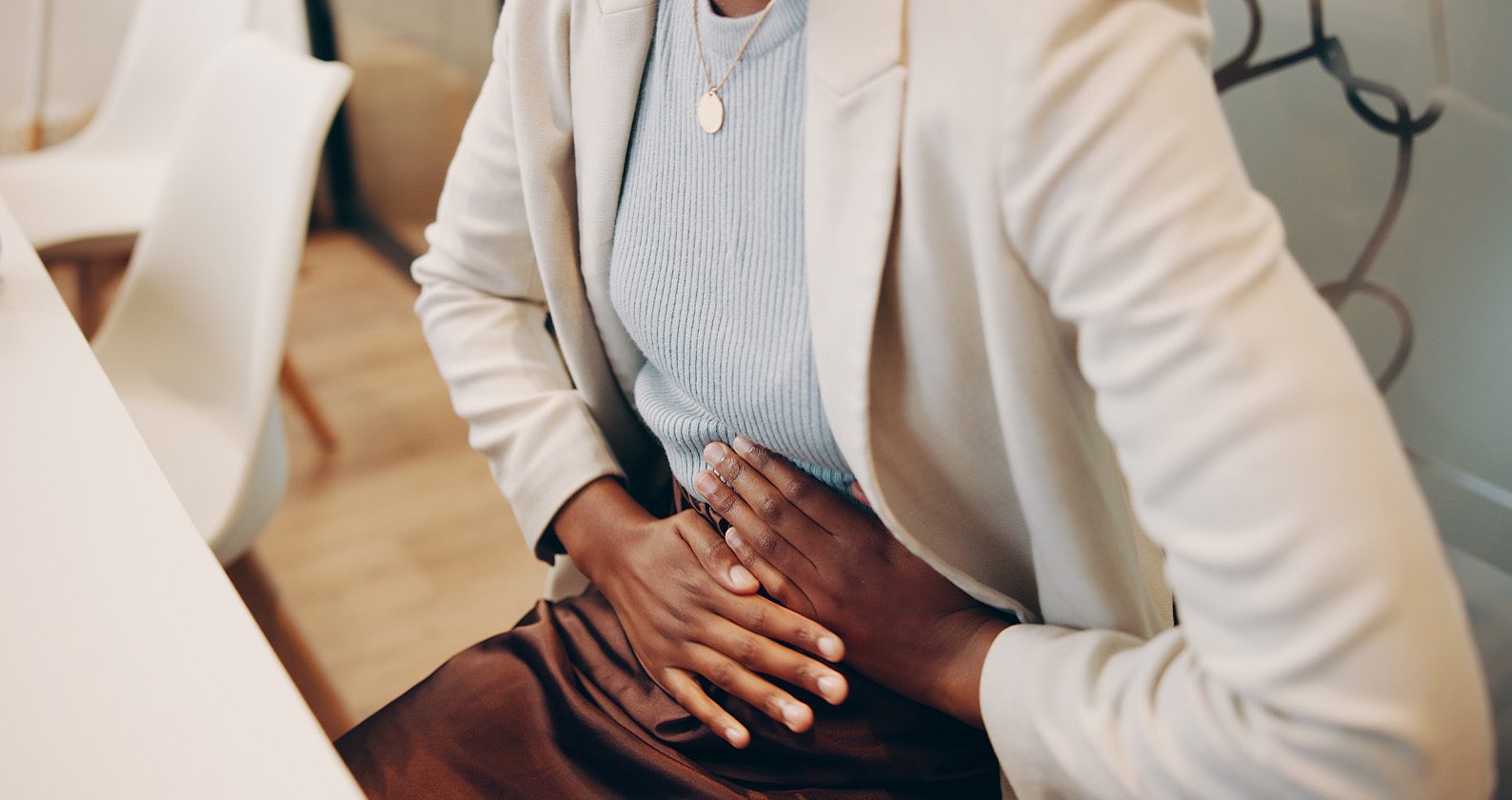 A women holding her stomach in pain