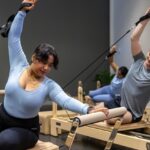 Students doing reformer pilates