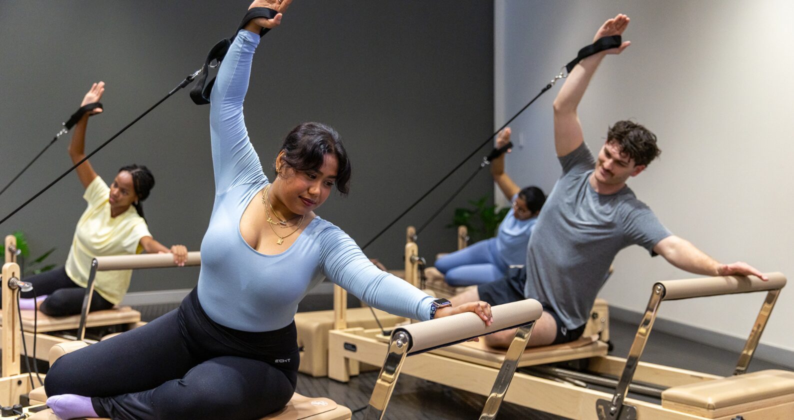 Students doing reformer pilates