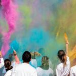 People participating in the colour run with colour powder around them