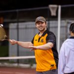 Student playing tennis