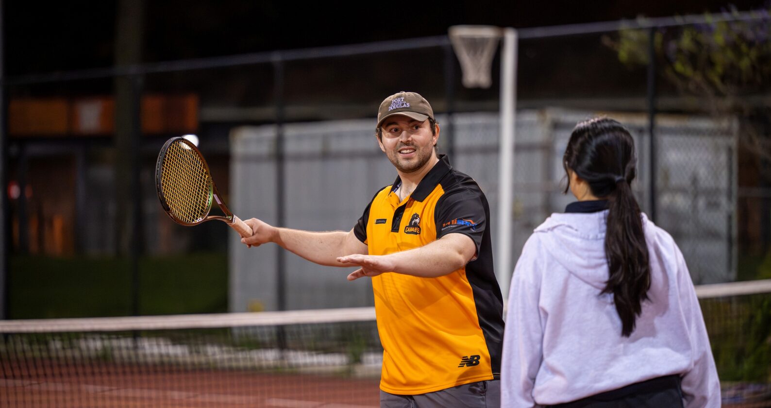 Student playing tennis