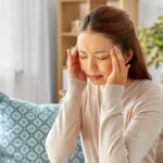 A person holding their head in pain