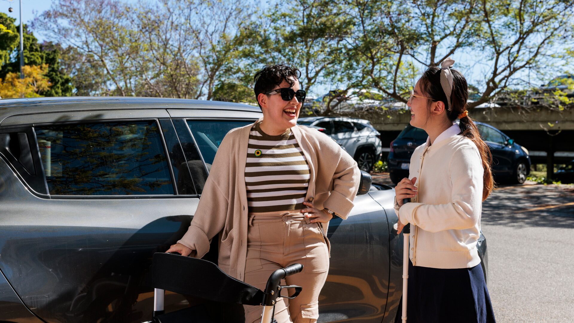 two students with disability chatting at a parking lot