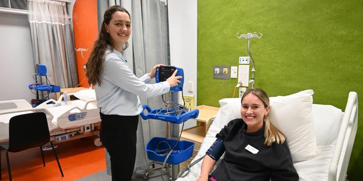 Two students in the simulated hospital ward.