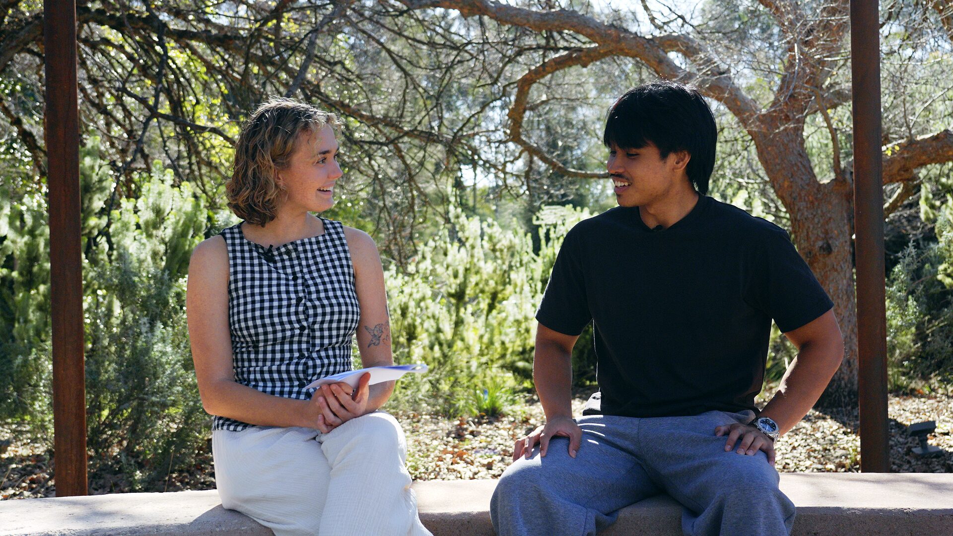 Musa and Bianca sitting at the Yarning Circle while learning Noongar language together.