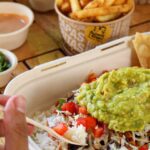 Person eating a burrito bowl
