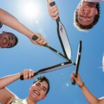 Group of students holding racquets.