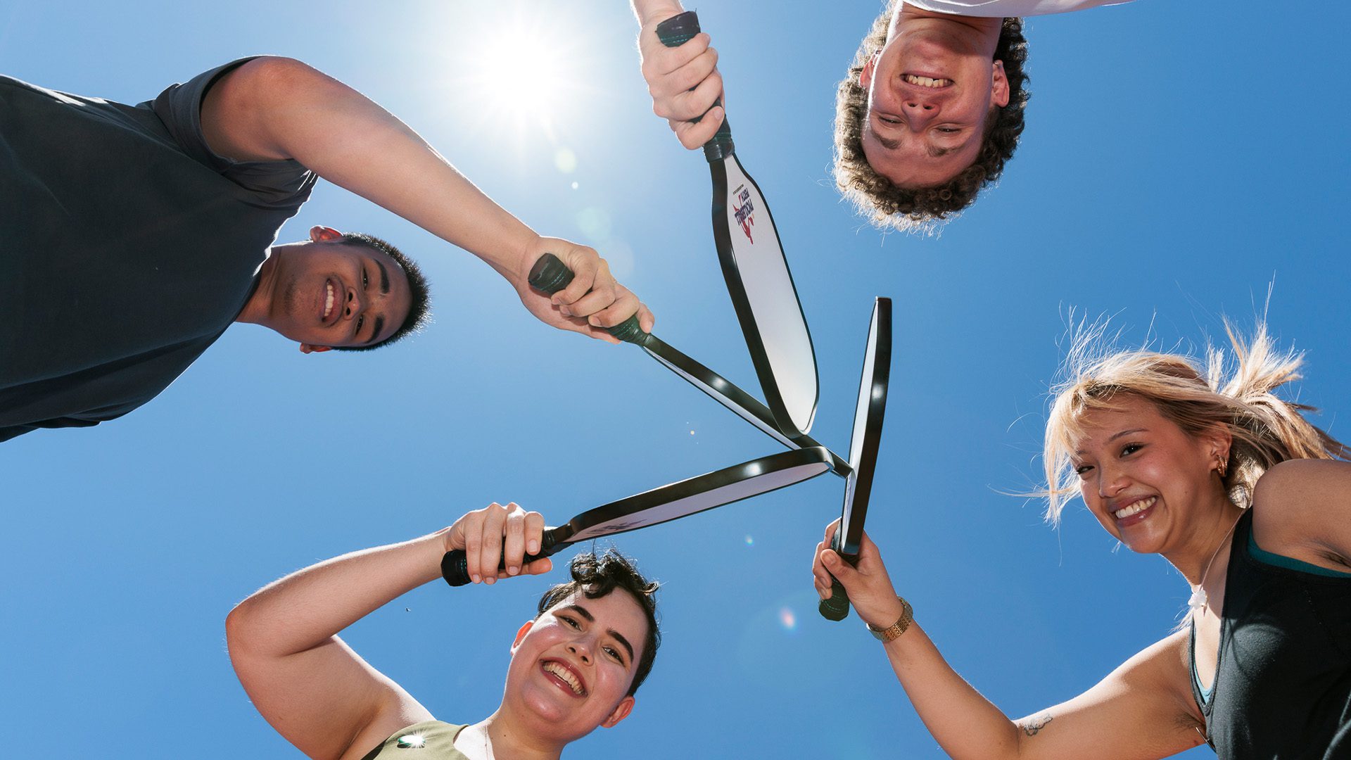 Group of students holding racquets.