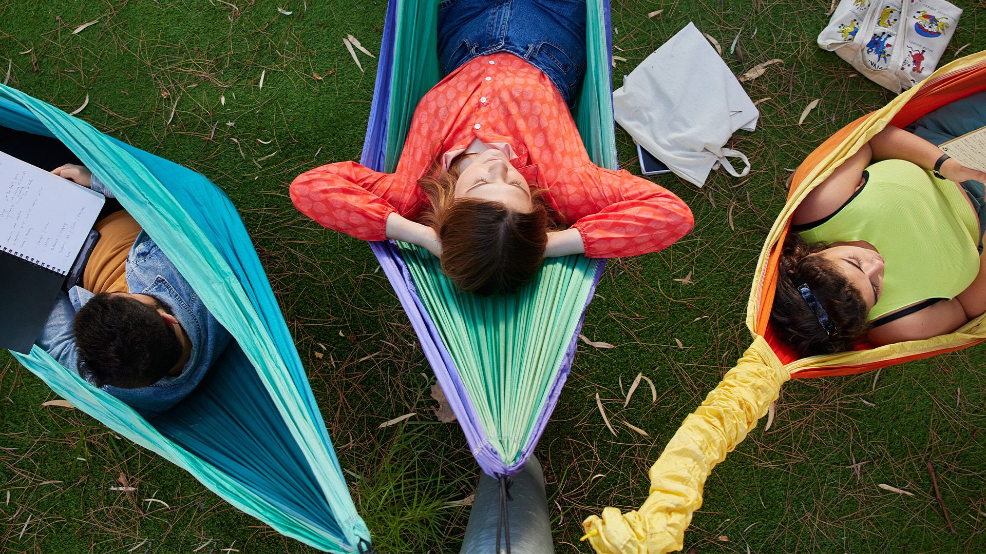 Students lying on hammocks.