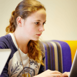 A girl looking at her laptop