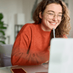 Person using a laptop at a desk.