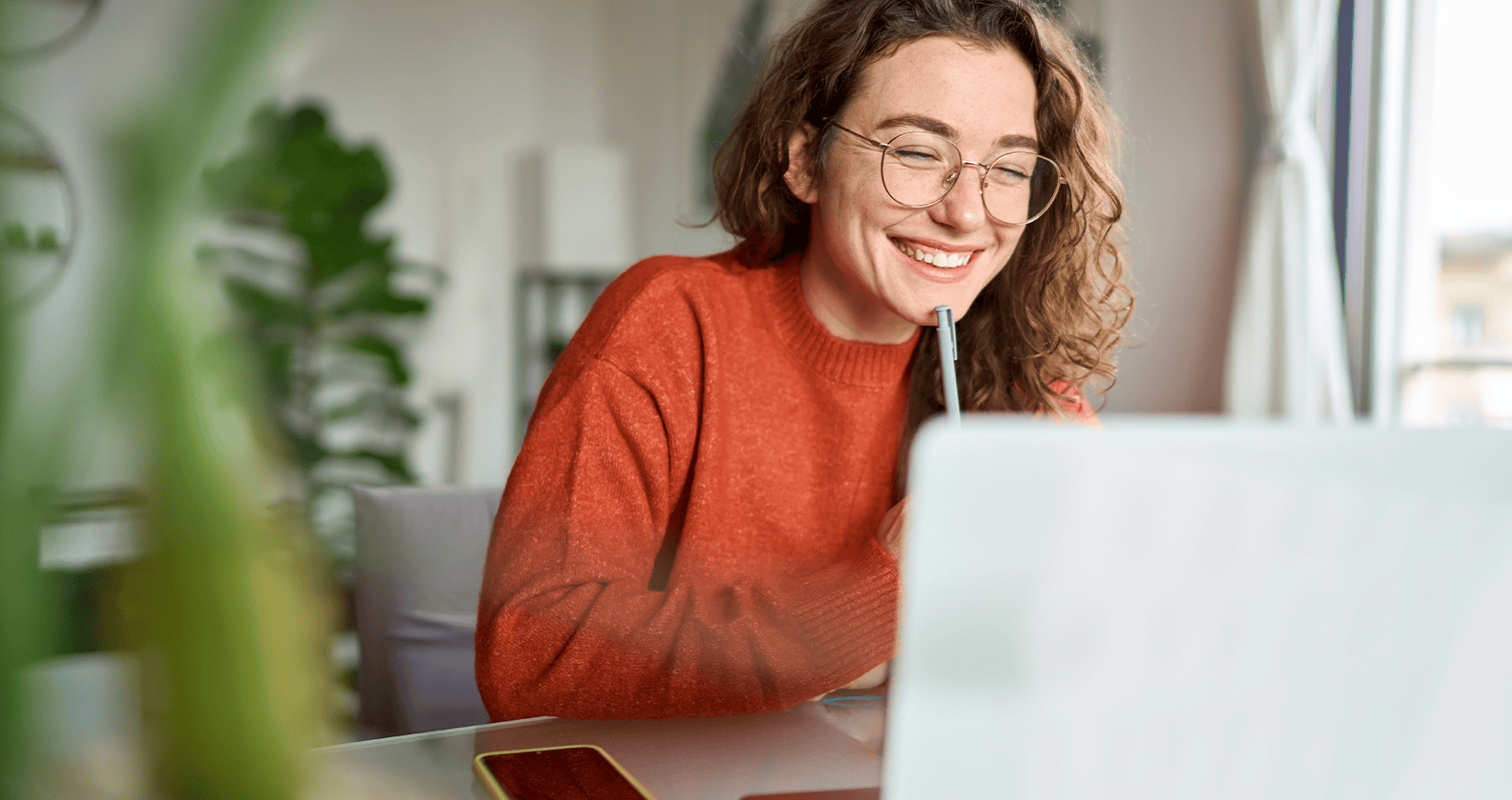 Person using a laptop at a desk.