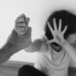 Child turns away from an adult in fear.