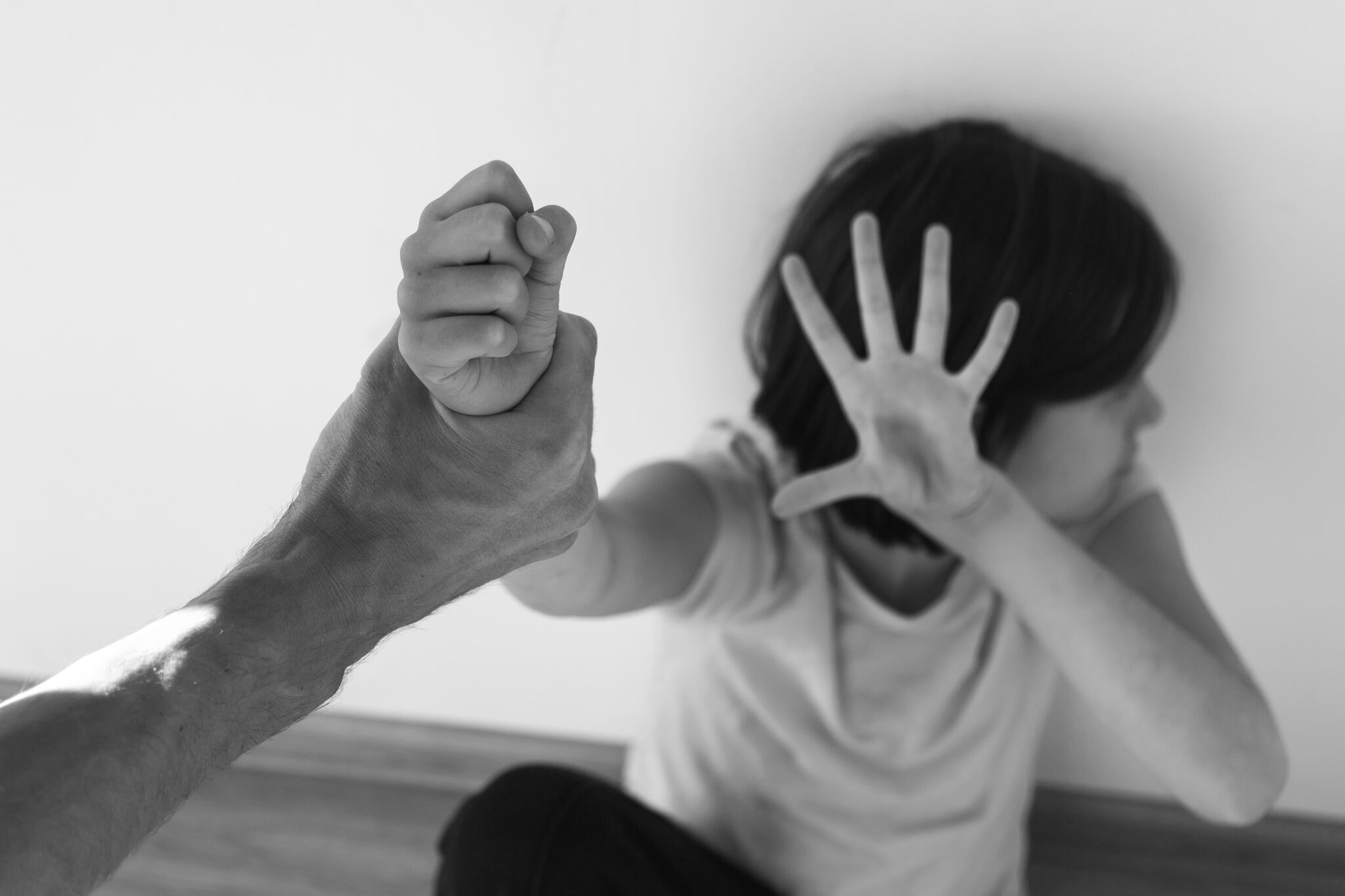 Child turns away from an adult in fear.