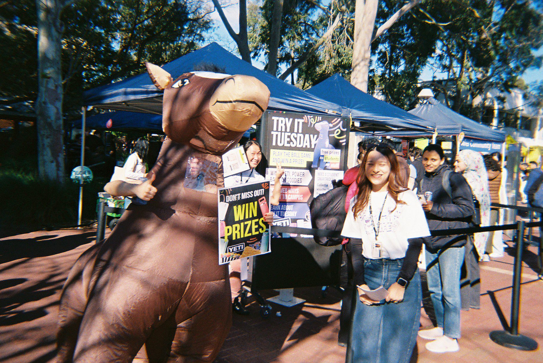 Student stood next to the Try it Tuesday O-Week Stall with an inflatable horse