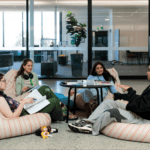 Four students sitting down and facing each other to discuss