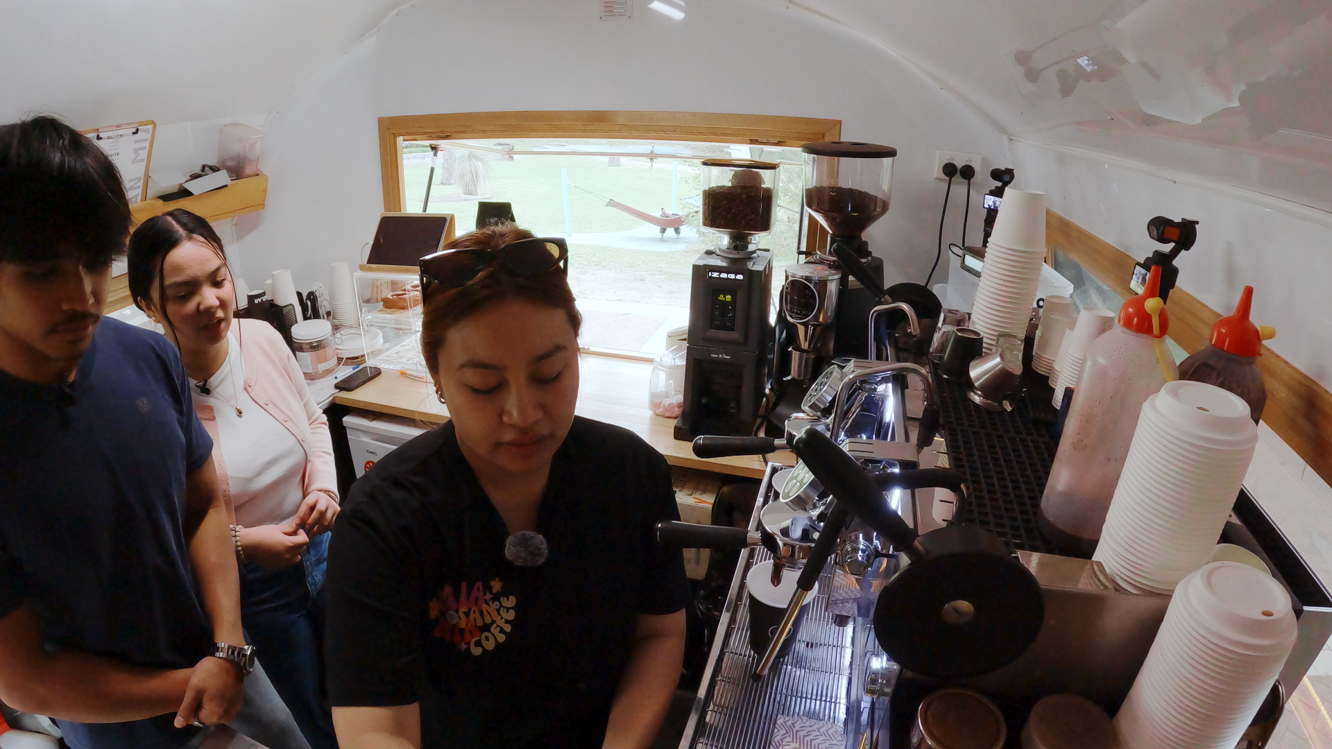 Image of three people making coffee at a van