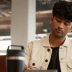 A male student looking down on this device