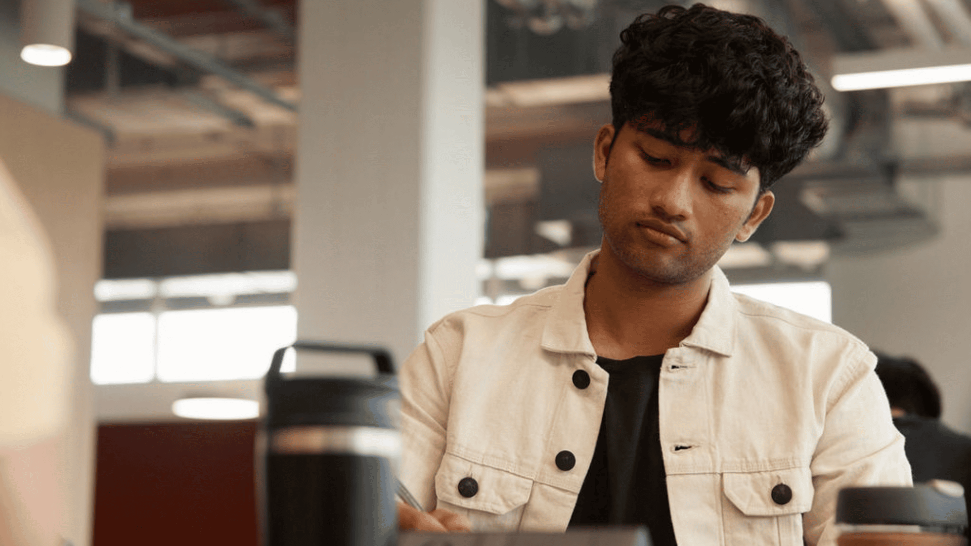 A male student looking down on this device
