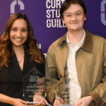 Two award recipients holding Excellence in Teaching Awards.