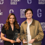 Two award recipients holding Excellence in Teaching Awards.