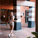 Person walking towards the Building 109 Counselling and Health Services entrance.