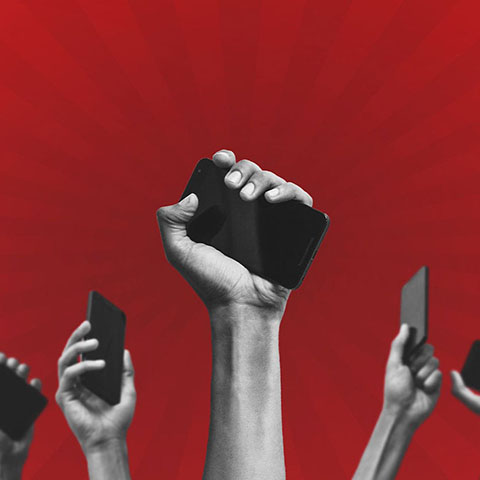 Hands in the air holding mobile phones with red background