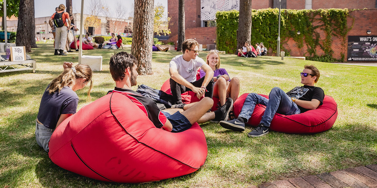 Students sitting on bean bags outdoors