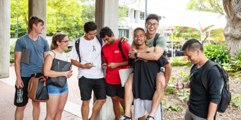A group of students gathered around a phone