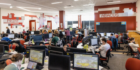 Room full of students studying on computers