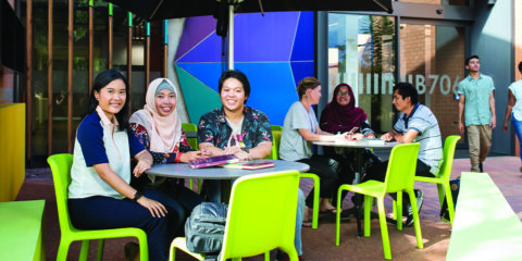 Students sitting on cafe chairs outside at Kalgoorlie campus