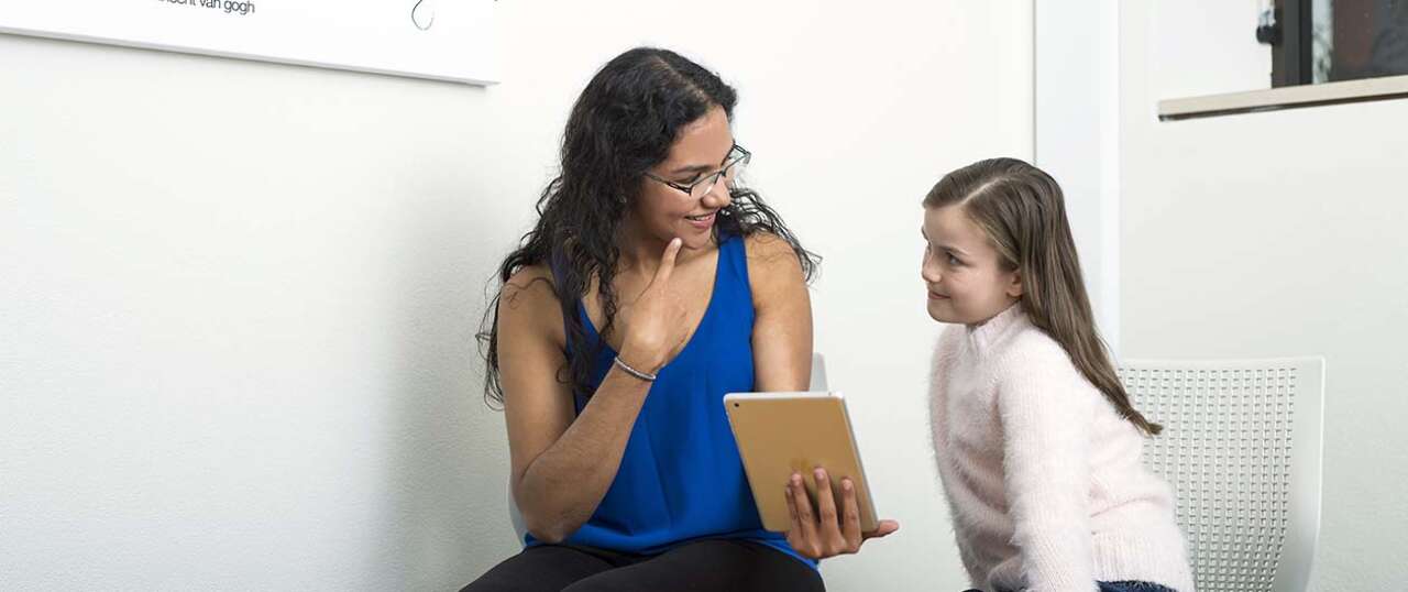 Speech Path student in consultation with child