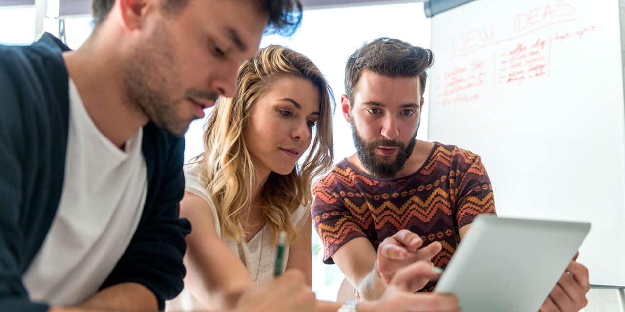 Students staring at a tablet