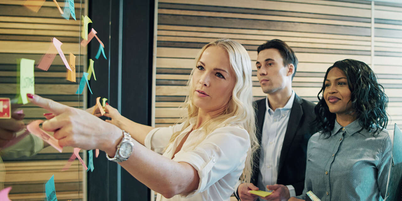 Business woman pointing at a board