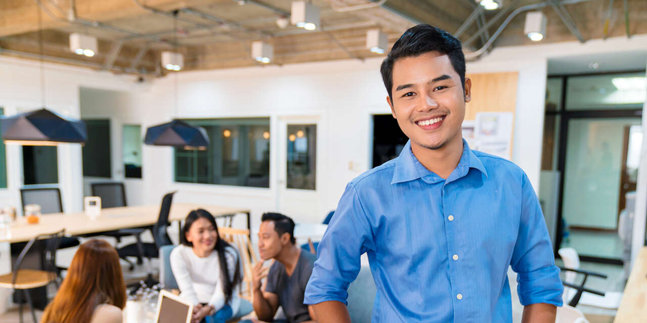 Student looking at the camera with other students in the background