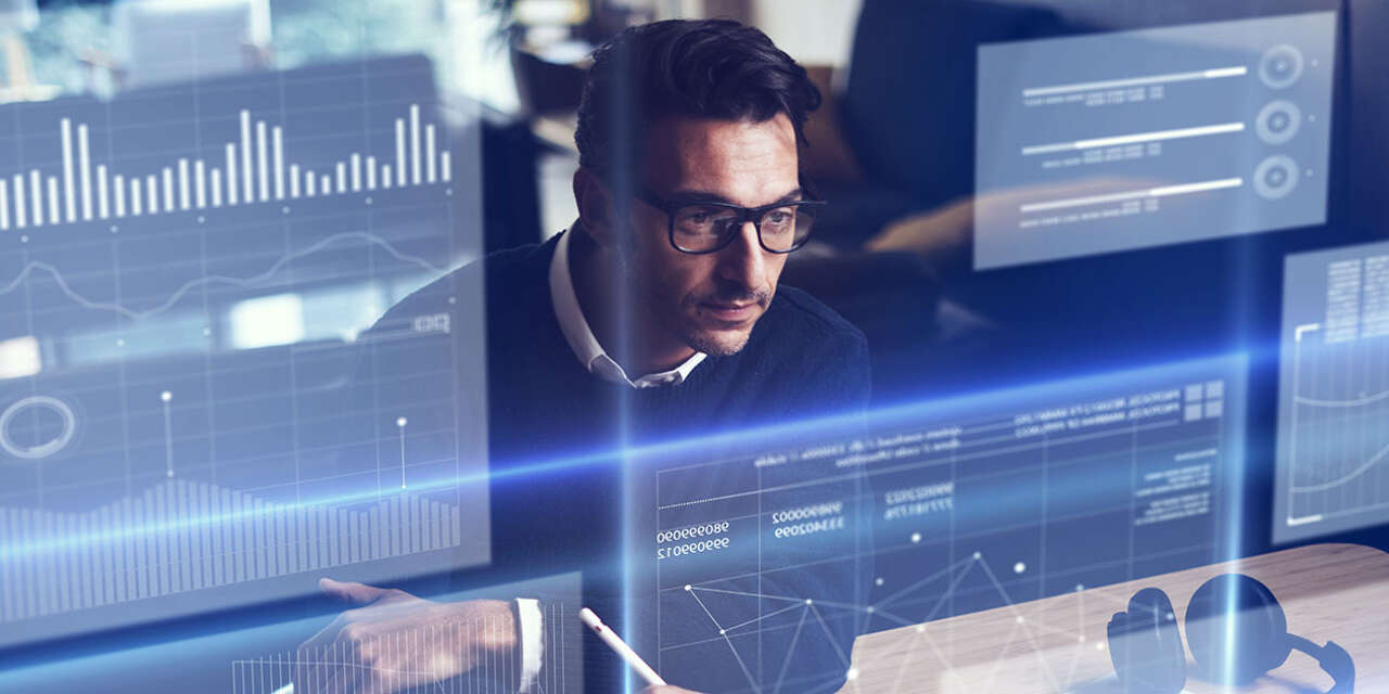 Businessman looking at digital display