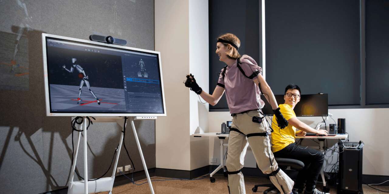 A person wearing a headset copying an animation on screen.