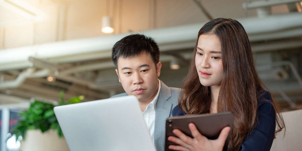 Two students looking at a tablet