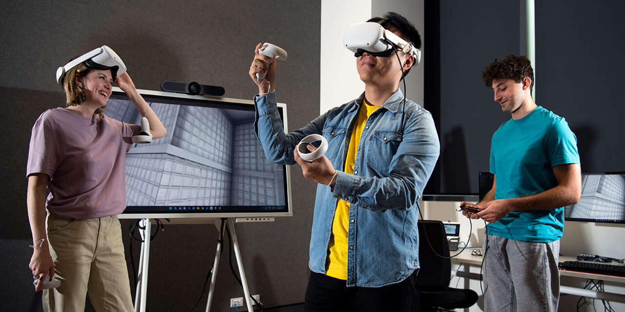 Three students testing out virtual reality headsets