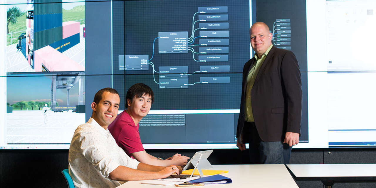 Students and tutor in a classroom in front of a screen