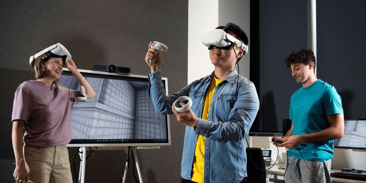 Person wearing virtual headset with two people in background.